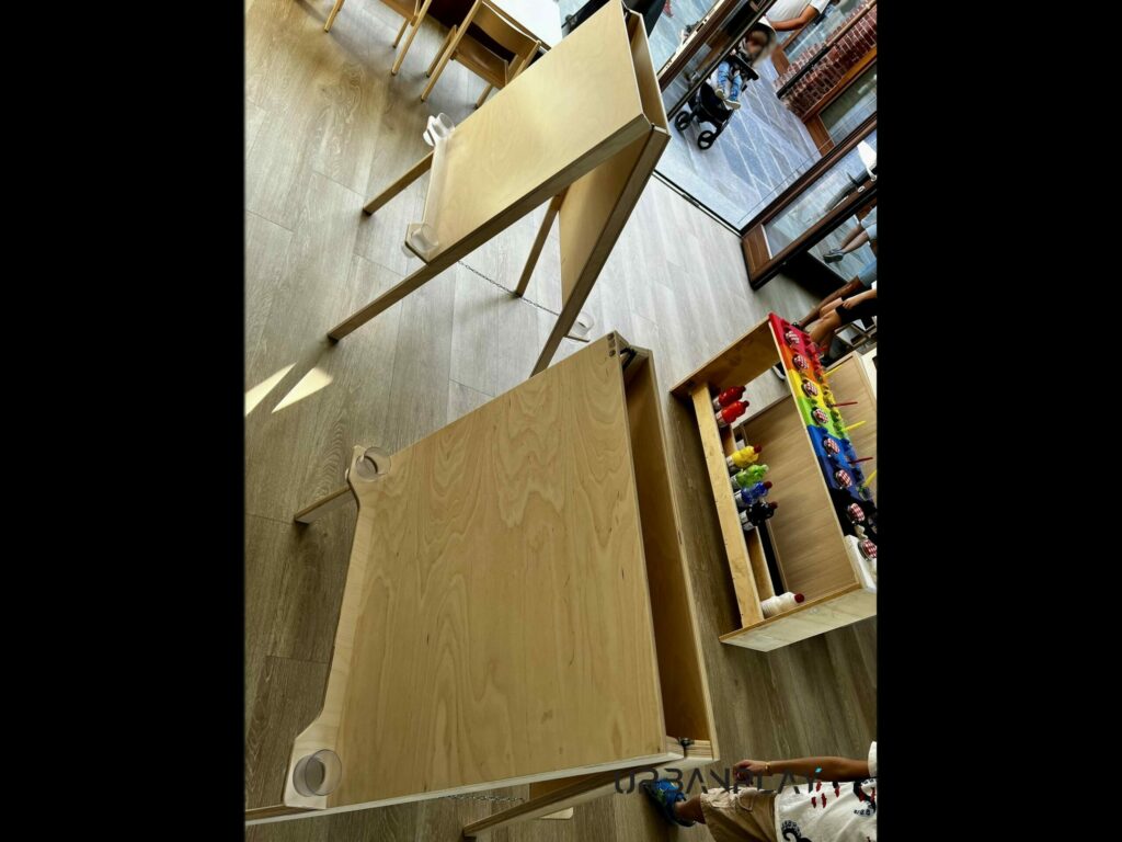 Scaffale educativo con materiali sensoriali e vassoi per attività autonome